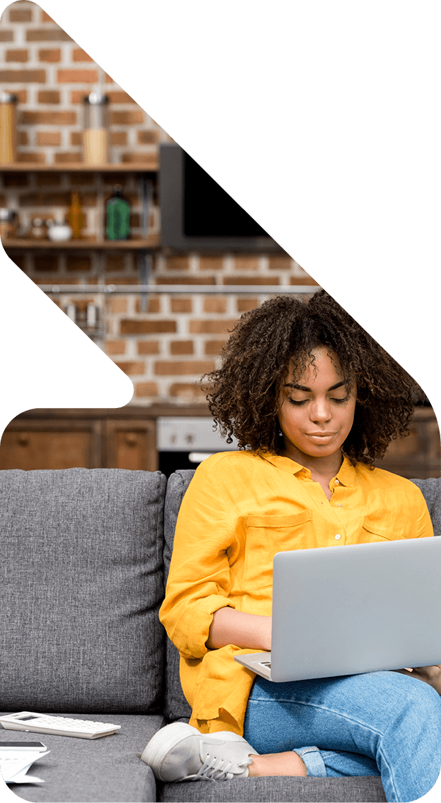Image showing a woman sitting on her couch using her laptop