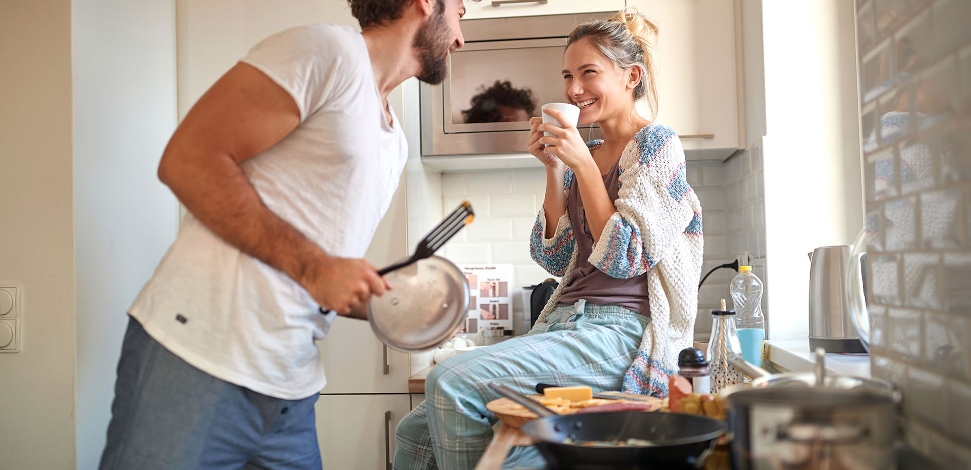 Image showing a smiling young couple cooking in their kitchen