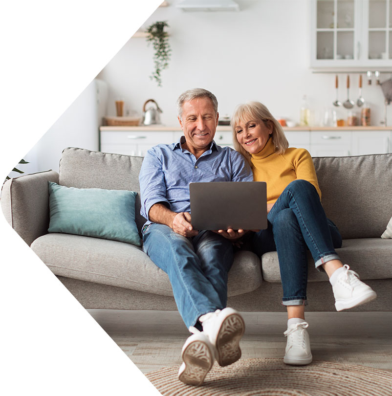 Image showing an older couple looking at their laptop together