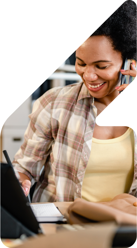 Image showing a woman on the phone in front of her laptop