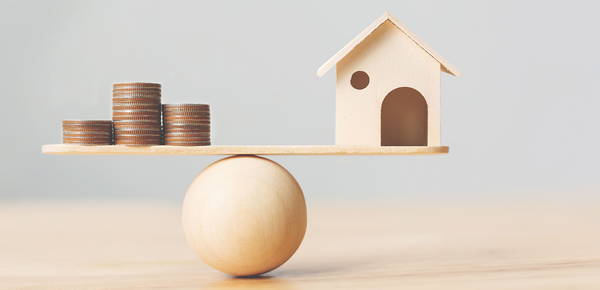 Image showing a model house and some coins on a balance beam