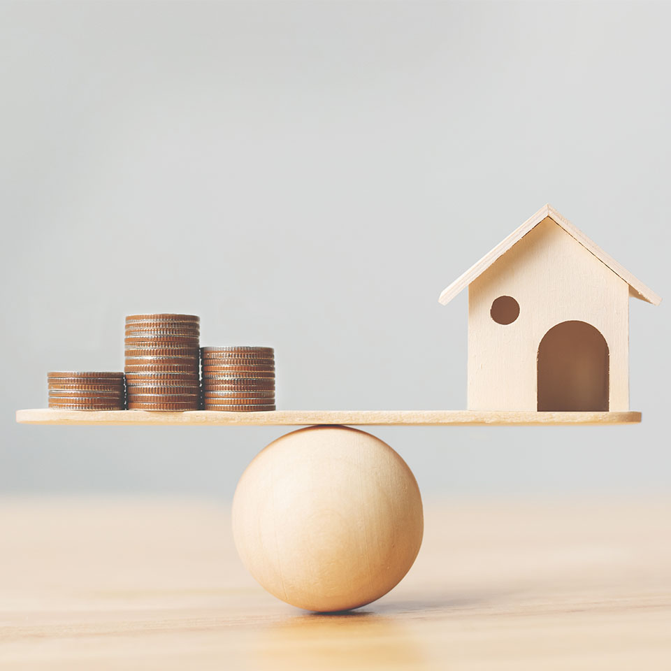 Image showing a model house and some coins on a balance beam