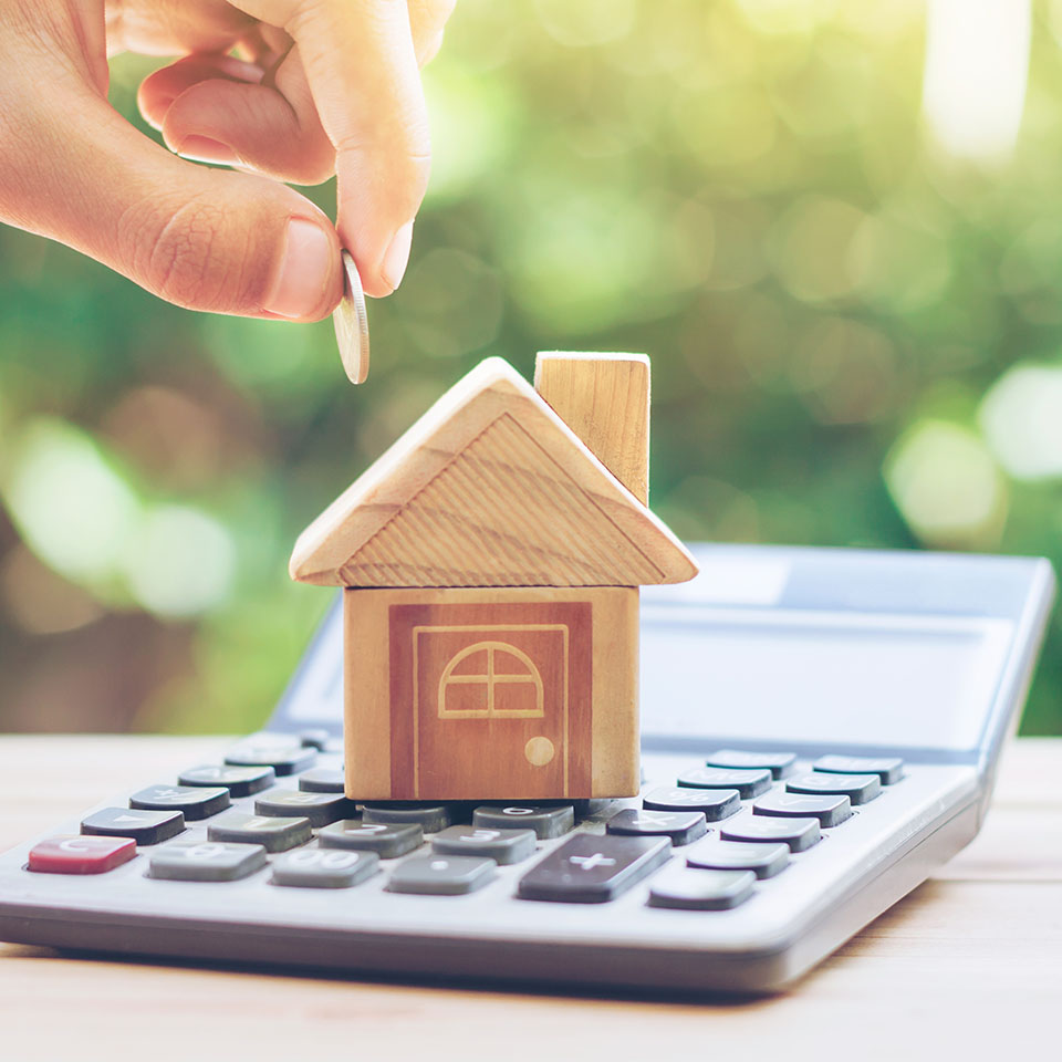 Image showing a model house on top of a calculator