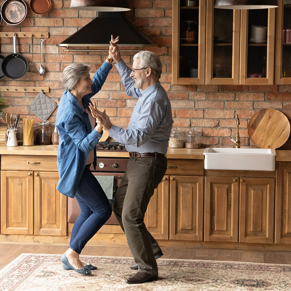 Image showing an older couple dancing in their kitchen