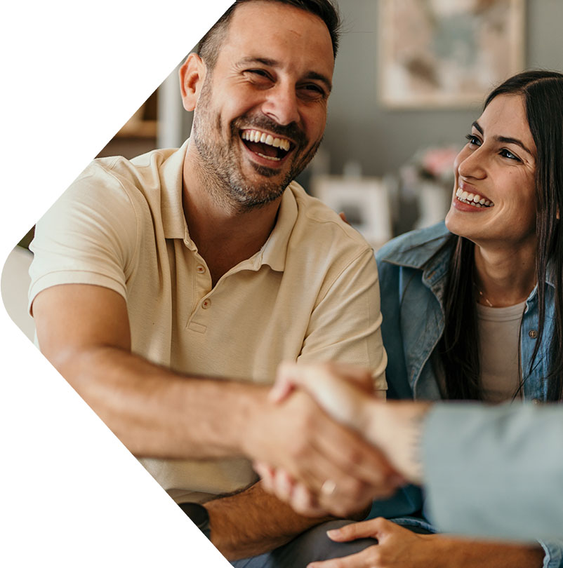 Image showing a smiling couple shaking hands with a broker